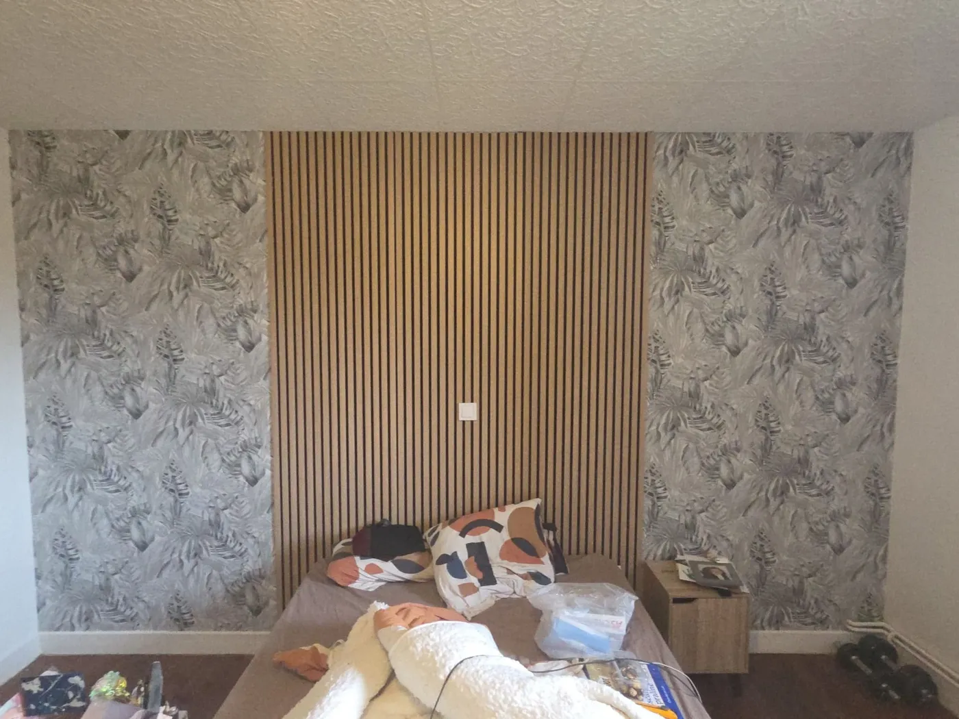 Mur d'accent en tasseaux de bois et papier peint végétal